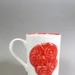 Mug - hei-tiki face; Studio Ceramics NZ Ltd; 2007; 2017.1.120