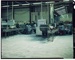 Transparency - Workers standing on factory floor, beside long benches of cup moulds; 1960s; 2008.1.3049
