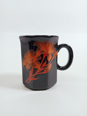 Mug - black hexagon with orange lilies; Crown Lynn Potteries Limited; 1980s; 2016.48.28