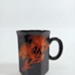 Mug - black hexagon with orange lilies; Crown Lynn Potteries Limited; 1980s; 2016.48.28