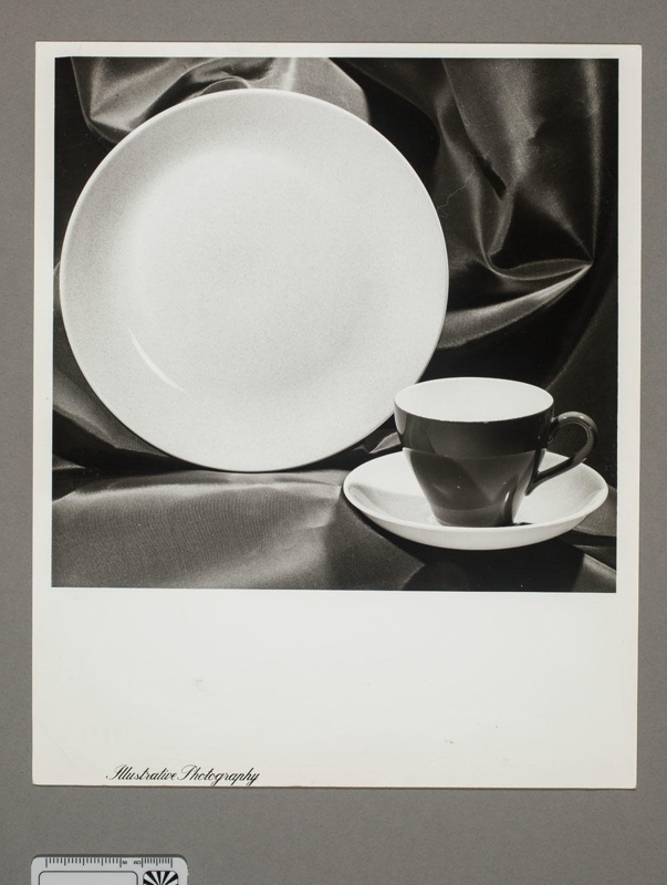 Photograph - display of plate, cup with saucer, on a cloth background