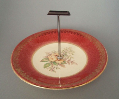 Cake plate and handle - floral; Crown Lynn Potteries Limited; 1950-1970; 2008.1.559.1-2