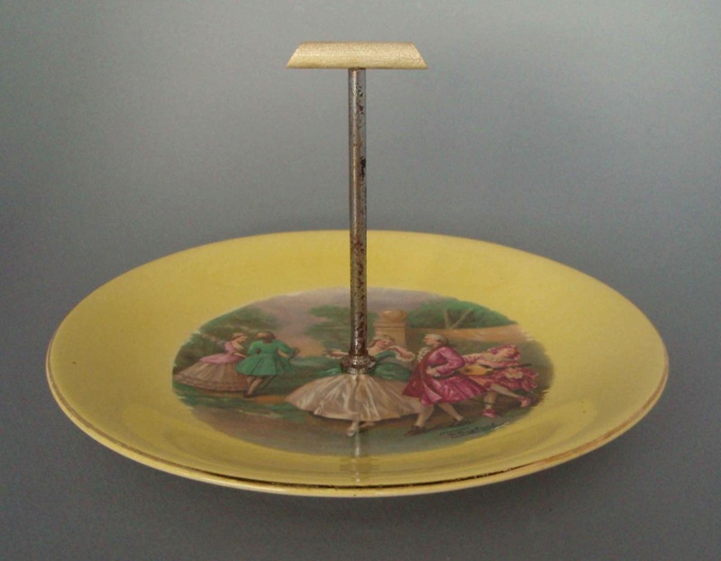 Cake plate and handle - dancers; Crown Lynn Potteries Limited; 1950-1970; 2008.1.560.1-2