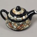 Cup and teapot set - Tapa pattern; Studio Ceramics NZ Ltd; 2002; 2017.1.6
