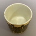 Cup with abstract design and matching saucer.; Crown Lynn Potteries Limited; 1970s; 2016.48.82