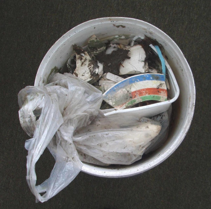 Bucket of objects dug from former Crown Lynn site