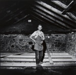 [Man standing on cross beam in attic].; Newton, Neil; c.a. 1972; 1974:0015:0015