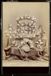 [Shrine with flowers with portrait of woman on a table with tapestry]; Curtiss and Smith; 1977:0036:0111