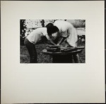 [Two stooped figures over a table]; Christian, John; 1969; 1982:0075:0005