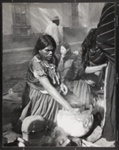 Tarascan Indian woman preparing food for Pal Sunday Fiesta on the second class bus plaza in Patzcuaro, Michocan, Mexico; Webb, Todd; 1966; 1982:0091:0001