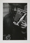 Untitled, [Man holding a glass drink bottle and a book of social commentary]. ; McLoughlin, Mike; 1964; 1974:0023:0001