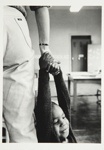 [Untitled, little boy hanging onto the hand of a nursery worker]. ; Heron, Reginald; 1966; 1972:0157:9999