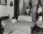 [Family Congregating in a Bedroom]; Crescenzi, Christine; 2000:0098:0002