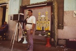 [Itinerant photographer with camera in front of painted backdrop showing shrine dedicated to St. Francis of the Stigmata, Caninde, Northeast Brazil].; Oettinger, Marion; 1990; 2009:0058:0003