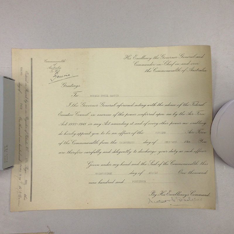 Enlistment certificate and mailing tube with stamps and postmark used 