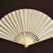 Reconstituted ivory folding fan with double silk leaf painted with a couple in 18th century dress. European, c. 1920; LDFAN1994.243