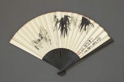 Wood fan with paper leaf advertising CAAC (China Airways); c. 1960; LDFAN2021.5
