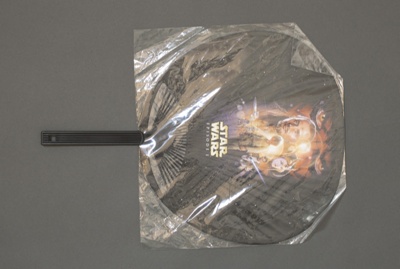 Fixed fan advertising 'Star Wars' inside its original clear plastic wrapper; 20th century; LDFAN2021.1