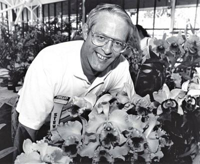 Photograph of Tony Beck with his prize winning orchids (Cattleya Mercia ...