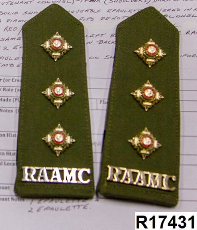 One pair of military shoulder epaulettes each with three pips and a
