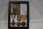 Three WW1 medals + photo in wood frame; LOWMS:2022.120
