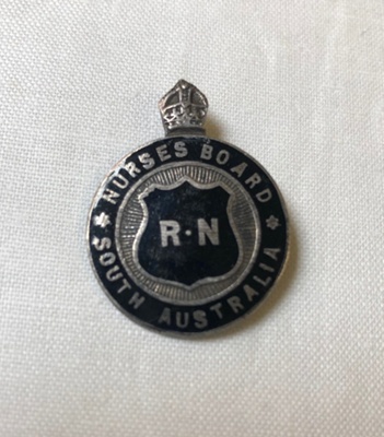 Badge: Nurses Board South Australia - Registered Mental Nurse (RMN) and Registered Nurse (RN) Badge; S. Schlank & Co (S .S & Co); Ca 1940; AR#1002