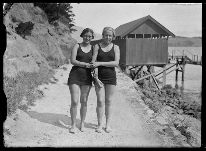 Two young women wearing swimwear, one appears to be wearing a belt over her swimwear. image item