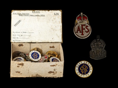 Cardboard box with 30 metal badges - ARP, AFS, REST CENTRE, and RNLI; CRMCH.1995.02
