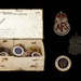 Cardboard box with 30 metal badges - ARP, AFS, REST CENTRE, and RNLI; CRMCH.1995.02