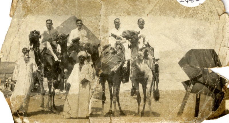 Photograph of 4 camels mounted by 4 Naval Ratings with 2 Arabs in the ...