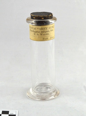 Small Clear Glass Specimen Jar with Cork Closure and Paper Label: Kino of Grey Gum; Hand blown; 1890s; 1999.161