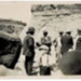 Photo, Group of men at beach, boy in hat in foreground; RAP2020.0129
