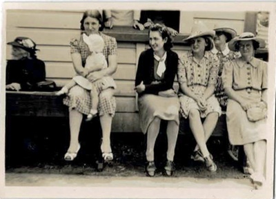 Photo, Six women sit in a row, one holds infant, Dec 1942; 1942; RAP2020.0161