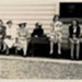 Photo, Elelven women sit in a row, one holds infant, Dec 1942; 1942; RAP2020.0162