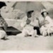 Photo, Three women with umbrellas at beach, baby and child; RAP2020.0013