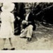 Photo, Jack Howell kneels before small girl; RAP2020.0133