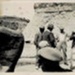 Photo, Men at beach, boy on rock, rock face in background; RAP2020.0010