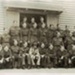 Photo, Twenty-five men in military dress pose before building; RAP2020.0134