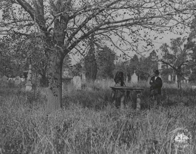 Evans Fawcus : Old Melbourne Cemetery, with Isaac Selby standing beside monument, c. 1920; Miller, Everard Studley, 1886-1956.; GS-TM-24