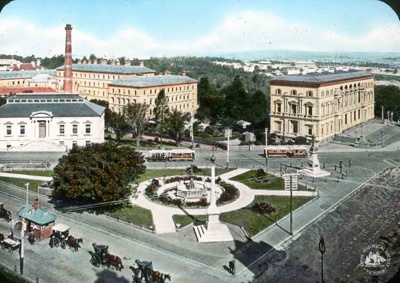 Elevated view across Carpentaria Place (later Gordon Reserve), Eight Hour Day Monument to Geological Museum, Macarthur Street, Government Printing Office and Treasury Building, Spring Street, Melbourne, c. 1910; T.W. Cameron (Firm); 1910; GS-BCS-15