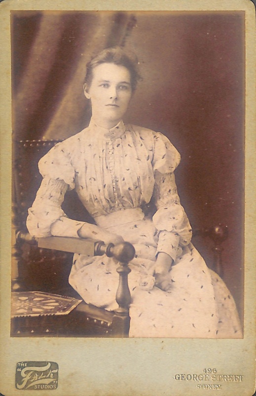 Studio portrait of an unknown woman in a white dress; Falk Studios; ca