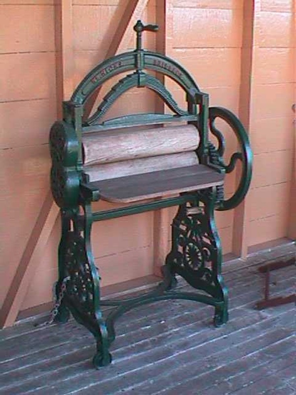 Mangle, large on cast iron stand with wooden rollers; W. H. Hicks