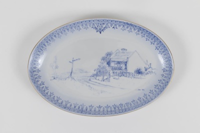 Dish, small, oval, white, illustration, blue, a street corner.; Unknown maker; 1983; 200.103