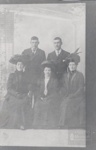 Two men standing and three women with hats sitting in photo studio; ULMPH 2000 0601 