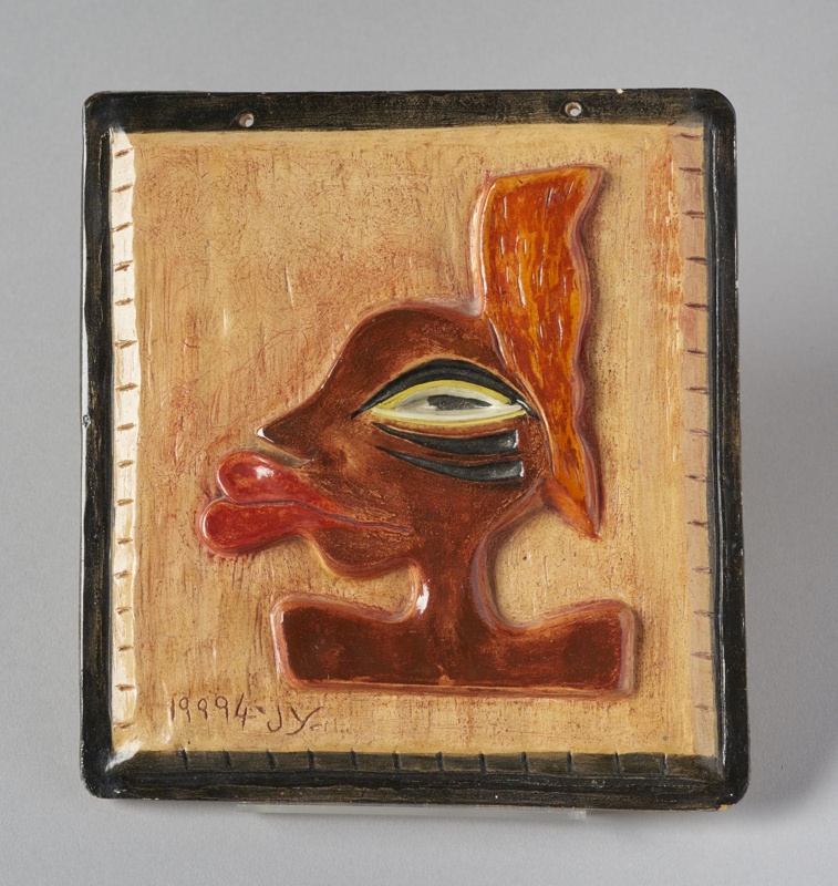 Square tile featuring a relief face in profile by Gheni York (1994)