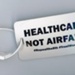 Luggage tag: HEALTHCARE NOT AIRFARE; London Irish ARC; 2018; GWL-2018-95