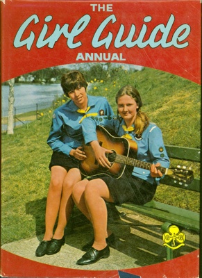 Front cover of The Girl Guide Annual for 1970 depicting two Guides on a bench, one strumming a guitar