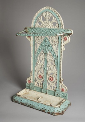 Cast iron umbrella stand painted in white, green, purple (faded).