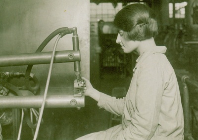 IET Archives postcard featuring black and white image of a woman using an early telephone system