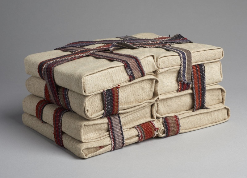 Secret Knowledge by Alinah Azadeh is a textile sculpture of eight cloth-wrapped books